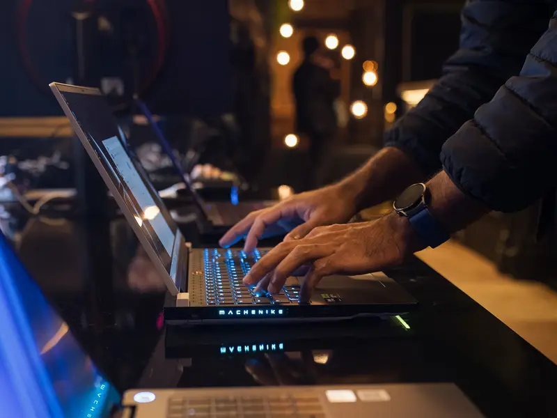 Developer working on a laptop at a live event